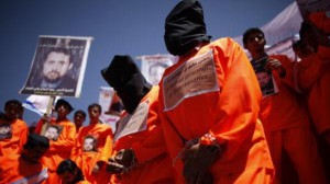 Former Guantanamo Bay detainees wear black hoods during a protest to demand the release of Yemeni detainees from Guantanamo Bay, outside the U.S. embassy in Sanaa April 16, 2013. (Reuters)